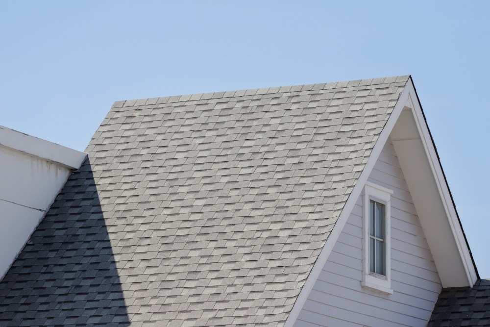 Gray shingled roof against sky